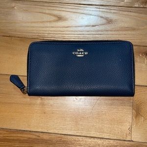 Navy blue leather/gold emblem coach wallet.